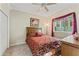 Comfortable bedroom featuring a cozy bed with patterned bedding and window view at 4959 Felecity Way, Palm Harbor, FL 34685