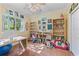 Bright bedroom with large window, ceiling fan, and shelves at 4959 Felecity Way, Palm Harbor, FL 34685