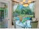 Dining area with pool view through sheer curtains and chandelier at 4959 Felecity Way, Palm Harbor, FL 34685