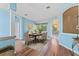 Elegant dining room with wood floors, chandelier, and views of the outdoor living area at 4959 Felecity Way, Palm Harbor, FL 34685