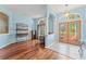 Elegant foyer featuring wood floors, arched doorways, and a decorative light fixture at 4959 Felecity Way, Palm Harbor, FL 34685