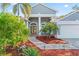 Inviting front entrance with double doors, arched windows, and well-maintained landscaping at 4959 Felecity Way, Palm Harbor, FL 34685