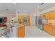Open-concept kitchen with granite countertops, stainless steel appliances and breakfast bar seating at 4959 Felecity Way, Palm Harbor, FL 34685