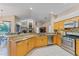 Open kitchen with stainless steel appliances and mosaic backsplash, perfect for cooking and entertaining at 4959 Felecity Way, Palm Harbor, FL 34685