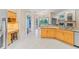 Kitchen area leading to dining and living room with patio and backyard views at 4959 Felecity Way, Palm Harbor, FL 34685