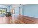 Open concept living room with wood floors and views of the front entrance at 4959 Felecity Way, Palm Harbor, FL 34685