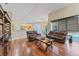 Hardwood living room with leather furniture and open view to the kitchen at 4959 Felecity Way, Palm Harbor, FL 34685