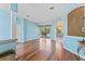 Inviting living room with wood floors, arched doorways, and neutral paint, creating a warm ambiance at 4959 Felecity Way, Palm Harbor, FL 34685