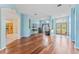 Bright, open living area with hardwood floors and arched doorways to other rooms in the house at 4959 Felecity Way, Palm Harbor, FL 34685