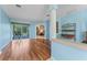 Bright living room with wood floors and large windows providing natural light at 4959 Felecity Way, Palm Harbor, FL 34685