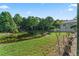 Picturesque pond with lily pads, trees, and green grass extending to the edge of the water at 4959 Felecity Way, Palm Harbor, FL 34685