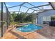 Private screened-in pool and spa area with an outdoor patio, perfect for relaxation and entertaining at 4959 Felecity Way, Palm Harbor, FL 34685
