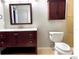 Bathroom featuring dark-wood vanity, a large mirror and tile floors at 5203 Oak Charter Ct # 5203, Temple Terrace, FL 33617