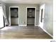 Bedroom featuring wood floors, gray walls, two closets, and a patio door at 5203 Oak Charter Ct # 5203, Temple Terrace, FL 33617