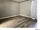 This bedroom features wood floors, light-grey walls and lots of natural light at 5203 Oak Charter Ct # 5203, Temple Terrace, FL 33617