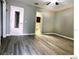 Spacious bedroom with wood-look flooring showing bathroom access and closet at 5203 Oak Charter Ct # 5203, Temple Terrace, FL 33617