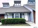 Charming condo with gray roof, white siding, and a well-maintained green hedge at 5203 Oak Charter Ct # 5203, Temple Terrace, FL 33617