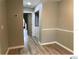 This hallway features wood floors and white trim at 5203 Oak Charter Ct # 5203, Temple Terrace, FL 33617