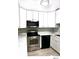 The kitchen has stainless steel appliances, white cabinets, and updated countertops at 5203 Oak Charter Ct # 5203, Temple Terrace, FL 33617