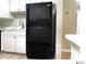 Kitchen shows a stainless steel sink with a black fridge and white countertops at 5203 Oak Charter Ct # 5203, Temple Terrace, FL 33617