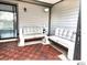 This charming screened patio features seating with cozy cushions and a decorative tile floor at 5203 Oak Charter Ct # 5203, Temple Terrace, FL 33617