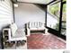 This cozy screened patio features seating with comfy cushions and a decorative tile floor at 5203 Oak Charter Ct # 5203, Temple Terrace, FL 33617