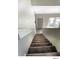 Carpeted staircase leads to a naturally lit foyer with wood-look floors at 5203 Oak Charter Ct # 5203, Temple Terrace, FL 33617