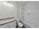 Well-lit bathroom with a tiled shower-tub combination and granite countertops at 5701 N 20Th St, Tampa, FL 33610