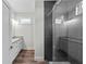 Modern bathroom with dual sinks, granite countertops, and a glass-enclosed shower at 5701 N 20Th St, Tampa, FL 33610