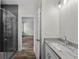 Bathroom featuring a walk-in shower and granite countertops at 5701 N 20Th St, Tampa, FL 33610