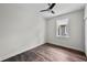 Cozy bedroom with wood-look floors, a bright window, and ample natural light at 5701 N 20Th St, Tampa, FL 33610