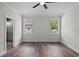 Bedroom with hardwood floors and ensuite bathroom featuring a sleek glass shower at 5701 N 20Th St, Tampa, FL 33610