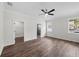 Spacious bedroom featuring wood-look floors, a ceiling fan, and access to a walk-in closet and ensuite bathroom at 5701 N 20Th St, Tampa, FL 33610