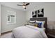 This bedroom features a ceiling fan, wood-look floors, and a large window at 5701 N 20Th St, Tampa, FL 33610