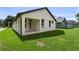 Exterior view showcasing a modern home design with a well-manicured lawn at 5701 N 20Th St, Tampa, FL 33610