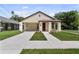 Inviting single-story home featuring brickwork, an open covered porch, and fresh landscaping at 5701 N 20Th St, Tampa, FL 33610