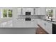 Modern kitchen with gray quartz countertops and white cabinets, stainless steel appliances at 5701 N 20Th St, Tampa, FL 33610
