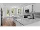 Modern kitchen featuring quartz countertops, stainless steel appliances, and white cabinetry at 5701 N 20Th St, Tampa, FL 33610