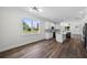Open floor plan showcases a bright kitchen with an island, modern appliances, and hardwood floors at 5701 N 20Th St, Tampa, FL 33610