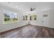 Inviting living room featuring hardwood floors, bright windows, and a stylish ceiling fan at 5701 N 20Th St, Tampa, FL 33610