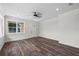 Bright living room boasts hardwood floors, a modern ceiling fan and neutral wall color at 5701 N 20Th St, Tampa, FL 33610