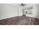 Spacious living area featuring hardwood floors, opening to the kitchen area, perfect for entertaining at 5701 N 20Th St, Tampa, FL 33610