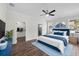 Bright main bedroom features wood floors, ceiling fan, walk-in closet, and natural light at 5701 N 20Th St, Tampa, FL 33610