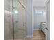 New bathroom, showcasing a glass enclosed shower with marble tile and chrome fixtures at 5703 N 20Th St, Tampa, FL 33610