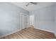 Bedroom with light blue walls, wood-look vinyl flooring, a ceiling fan, and closet at 5703 N 20Th St, Tampa, FL 33610