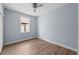 Bright bedroom featuring wood-look flooring, ceiling fan, and a window for natural light at 5703 N 20Th St, Tampa, FL 33610