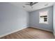 Bedroom featuring light blue walls, light wood-look vinyl flooring, ceiling fan, and one window at 5703 N 20Th St, Tampa, FL 33610