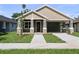 Charming single-story home with a covered porch, stone accents, and a well-manicured lawn at 5703 N 20Th St, Tampa, FL 33610