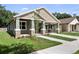 Inviting home with decorative stone pillars, an attached carport, and manicured landscaping at 5703 N 20Th St, Tampa, FL 33610