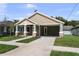 Charming home featuring a covered front porch, stone accents, and a well-manicured lawn at 5703 N 20Th St, Tampa, FL 33610